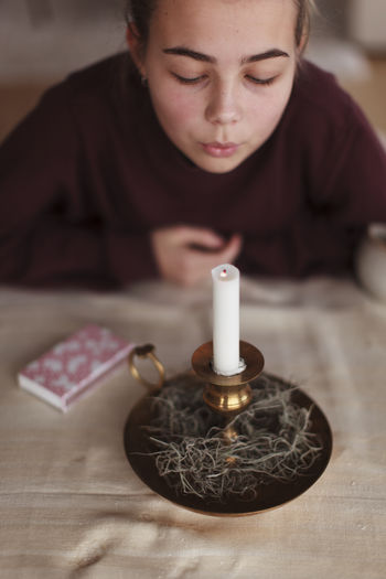 Girl blowing candle