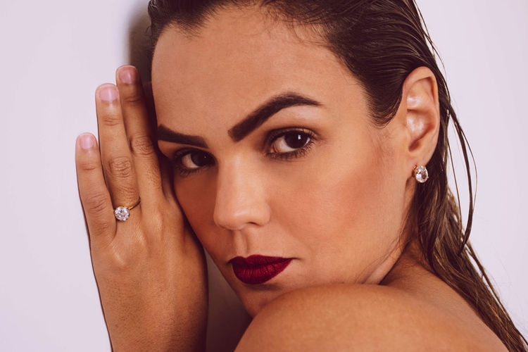 Close-up portrait of beautiful woman over white background