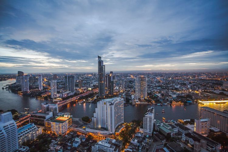 High angle view of illuminated city buildings against sky