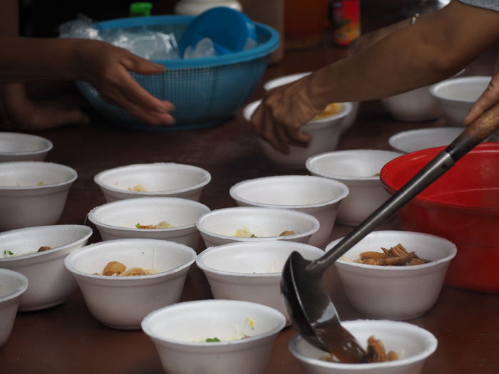 Cropped image of women preparing food on table