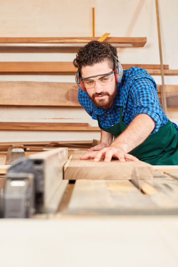 Man working on wood in workshop