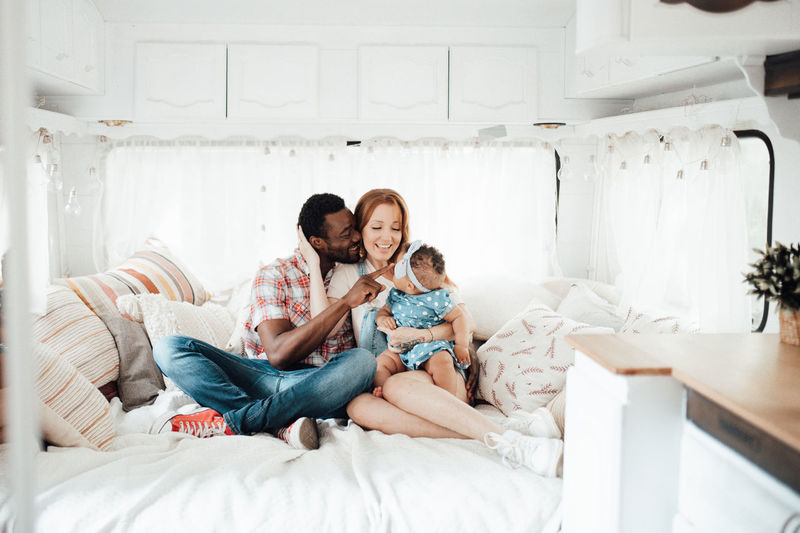 Cheerful family siting in camper van