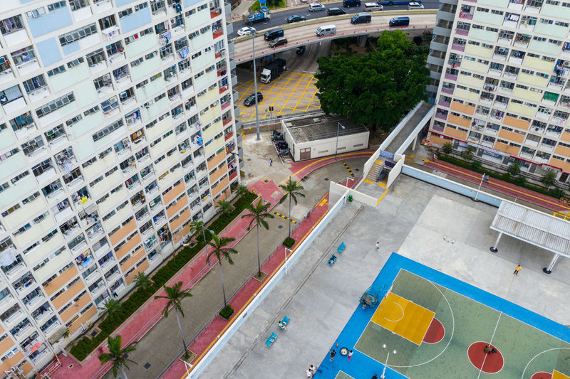 High angle view of buildings by playground in city