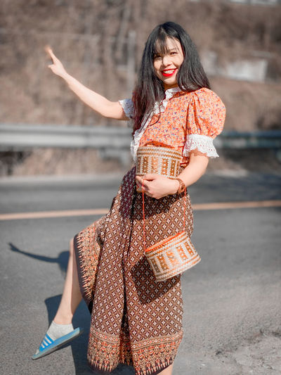 Portrait of young woman standing outdoors