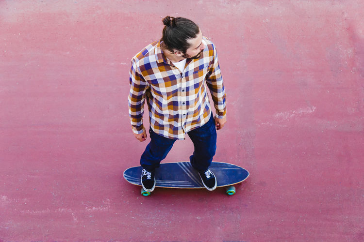 Full length of man skateboarding on wall