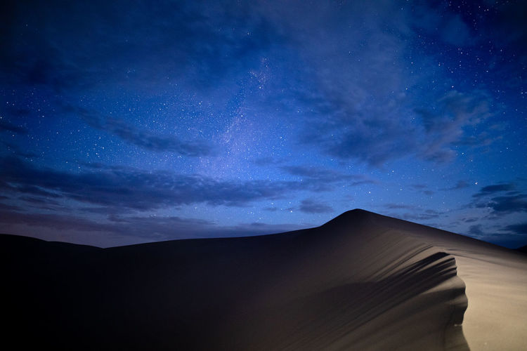 Low angle view of desert against sky at night