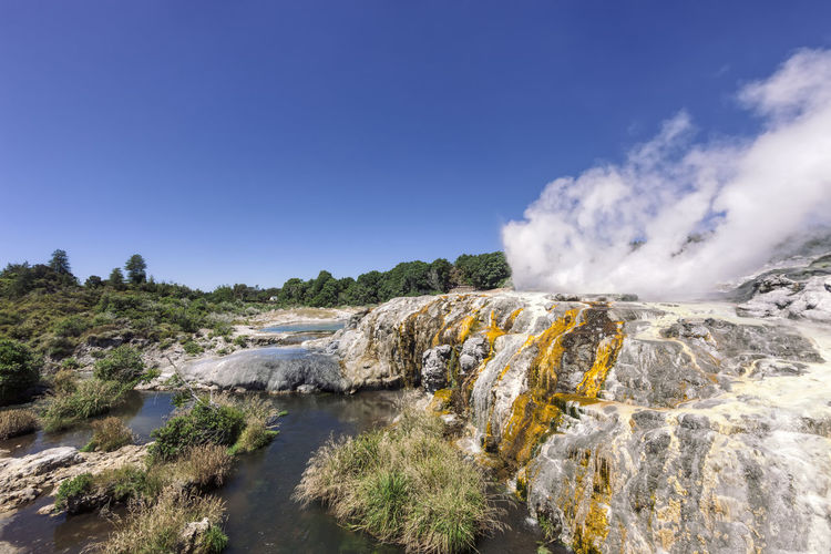 Scenic view of waterfall against sky