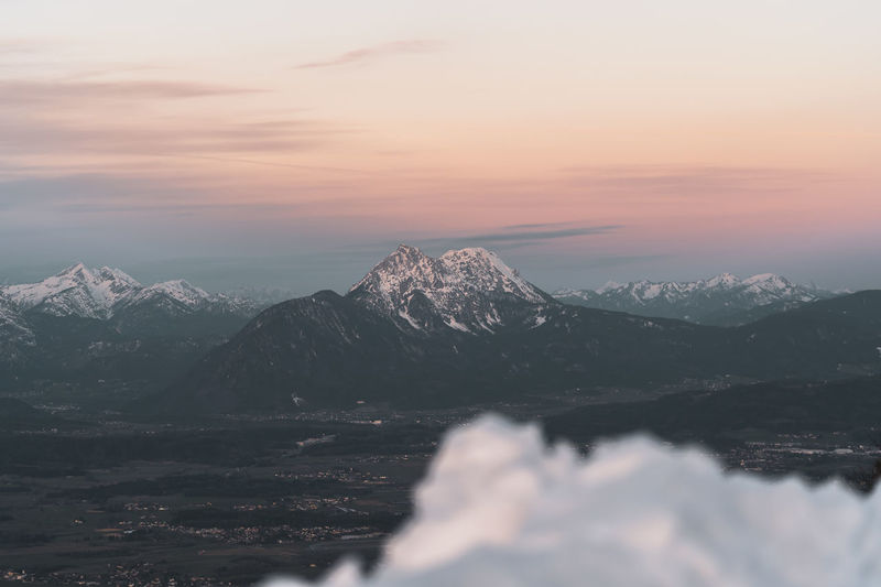 Scenic view of snowcapped mountains against sky during sunset