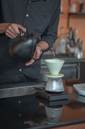 Man pouring coffee in cup