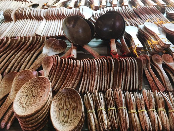 Full frame shot of wooden spoons and forks for sale at market