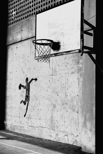 Close-up of basketball hoop against wall