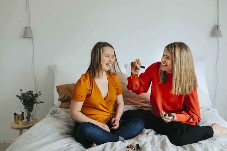 Young woman with down syndrome hanging out with girlfriend