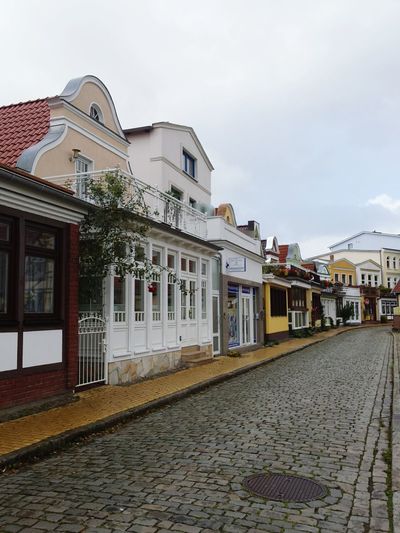 Street amidst buildings against sky