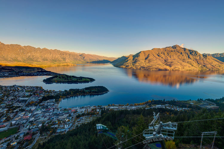 Aerial view of lake and mountains against clear sky during sunset