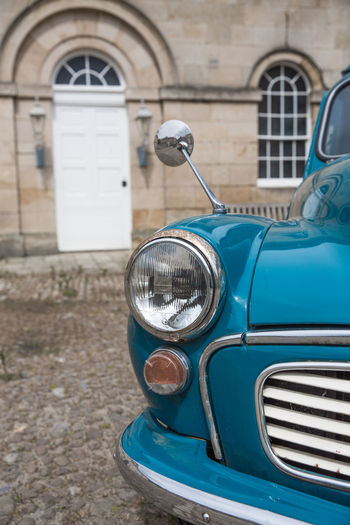 A classic duck egg blue, vintage morris minor car in close up in a luxury lifestyle setting