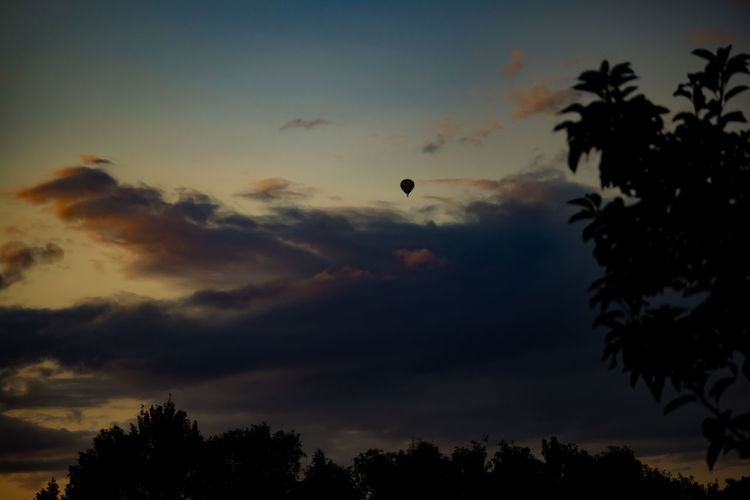 Low angle view of silhouette hot air balloon against sky