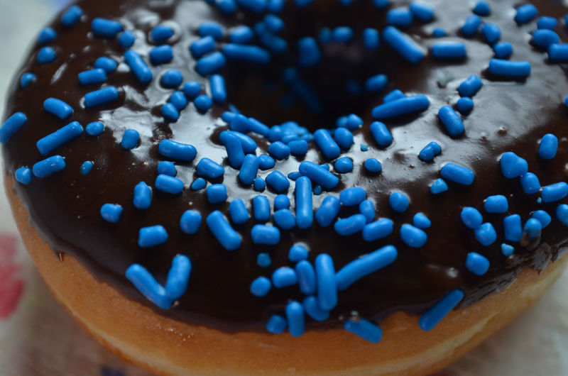 Close-up of donut with blue sprinkles