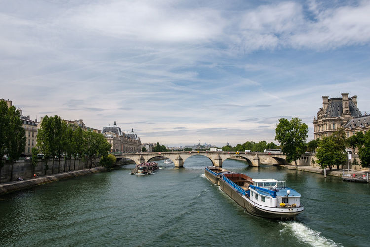 Boats in river with city in background