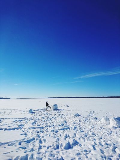 Man on snowcapped mountain against clear blue sky