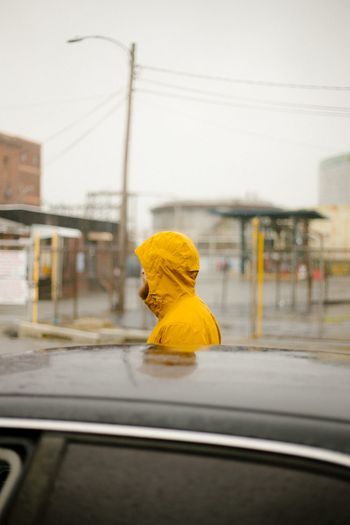 Side view of person with umbrella in car
