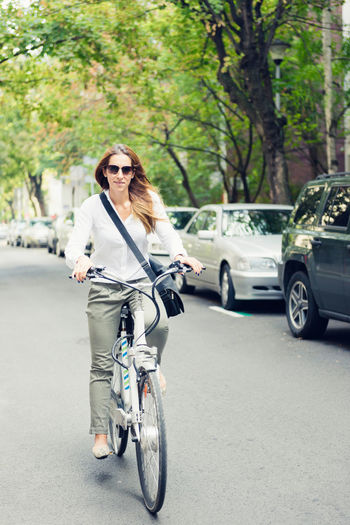 Woman riding bicycle on road