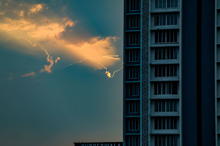 Low angle view of building against sky at sunset