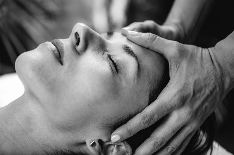 Craniosacral therapy massage. cst therapist massaging of womans head.