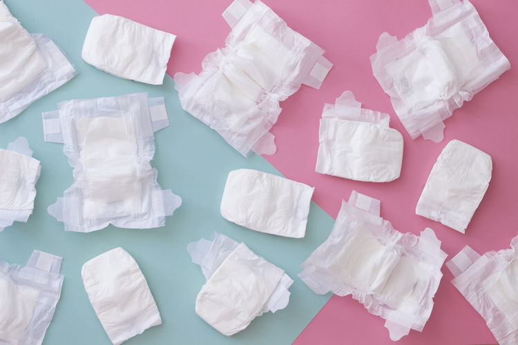 High angle view of diapers over colored background