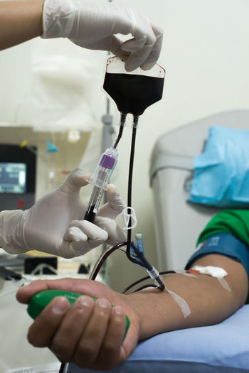 Cropped hands of doctor testing patient blood in hospital