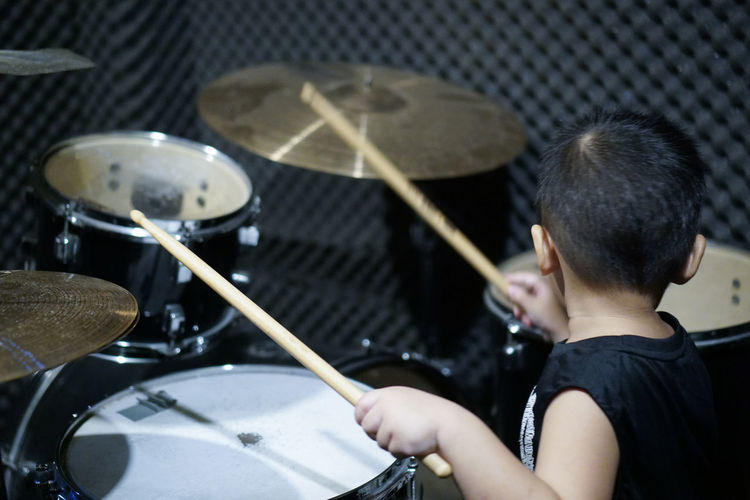 Boy playing drum at home