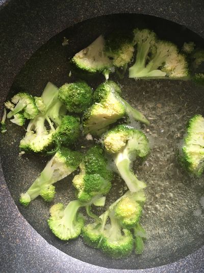 High angle view of chopped broccoli vegetables in pan