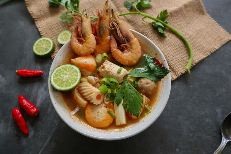 Tom yam soup originating from thailand. tom yum is made with shrimp, chili, lime, chicken, fish, o