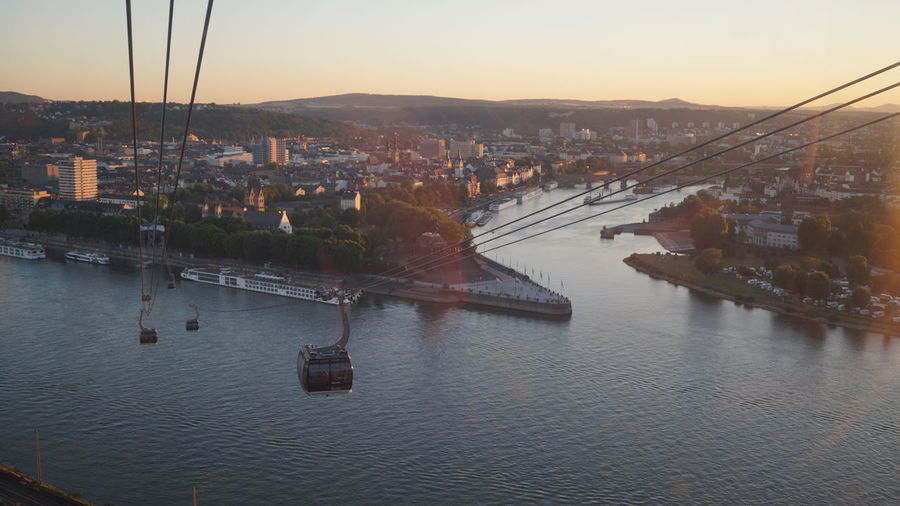 High angle view of overhead cable car over river in city