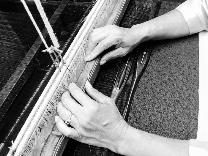 Close-up of person hand working at textile industry
