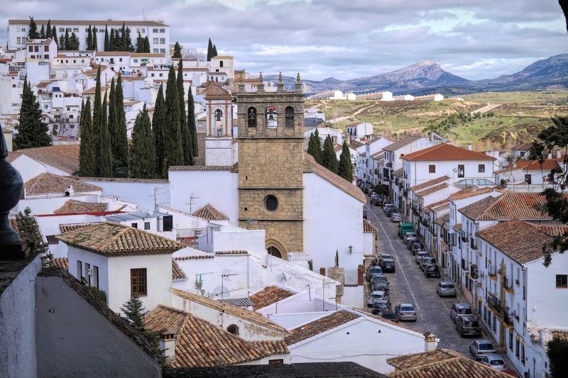 City view on street with white painted houses of the medieval famous city of ronda, andalusia, spain