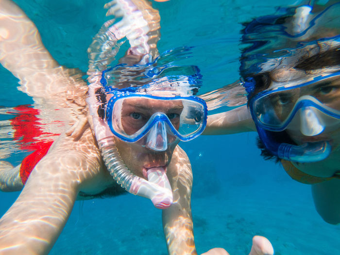Portrait of couple snorkeling in sea