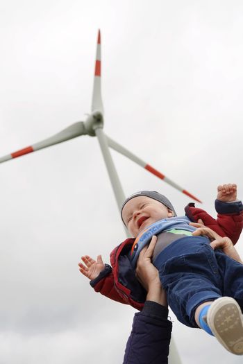 Baby boy near wind mill