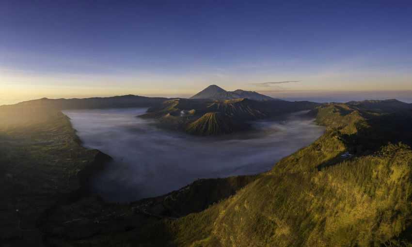 Scenic view of volcanic landscape against sky during sunset