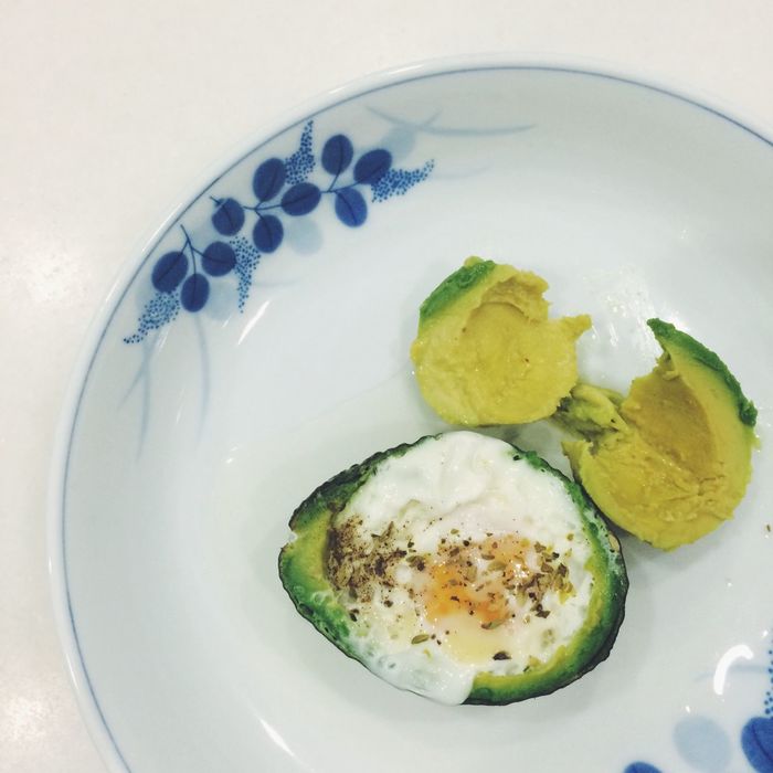 Close-up of avocado and egg served on plate