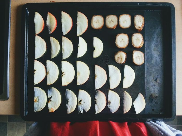 High angle view of apple slices on baking sheet