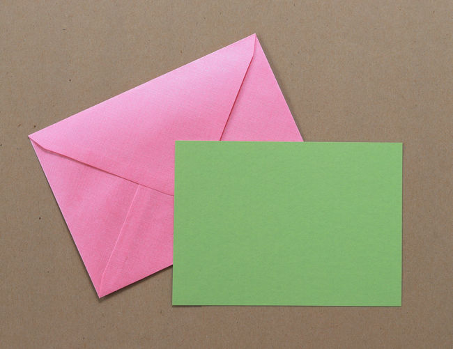 Close-up of paper and envelop over table