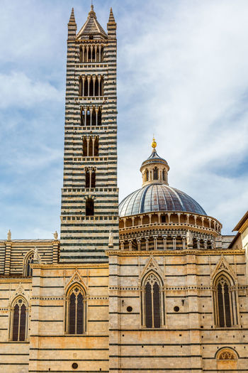 Facade of duomo di siena in italy with the bell tower