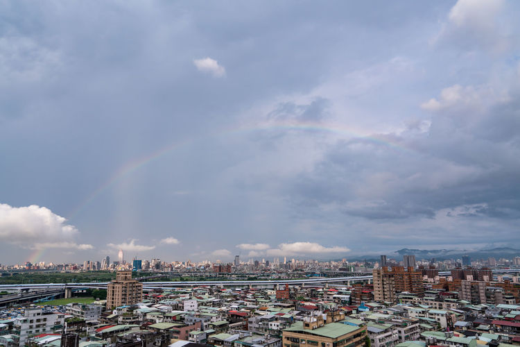 Panoramic view of rainbow over buildings in city