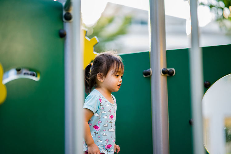 Girl standing on play equipment