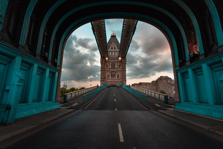 Road amidst buildings against sky in city