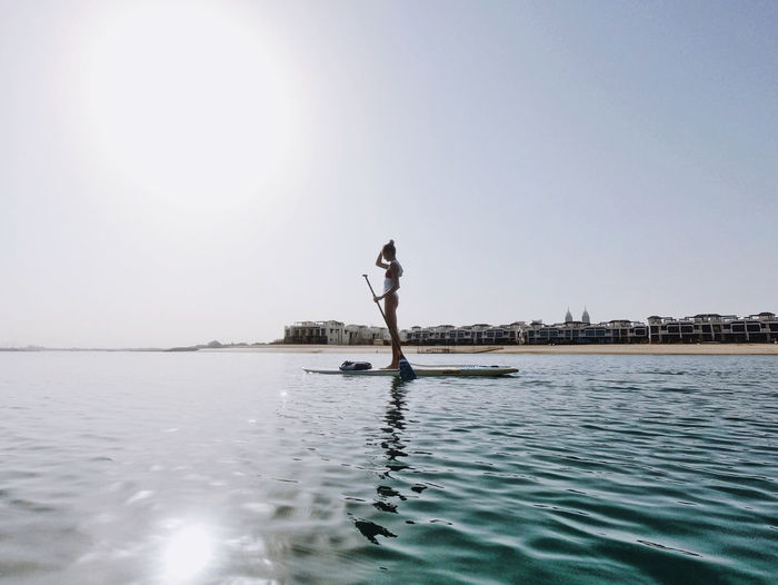Woman doing stand up paddle boarding