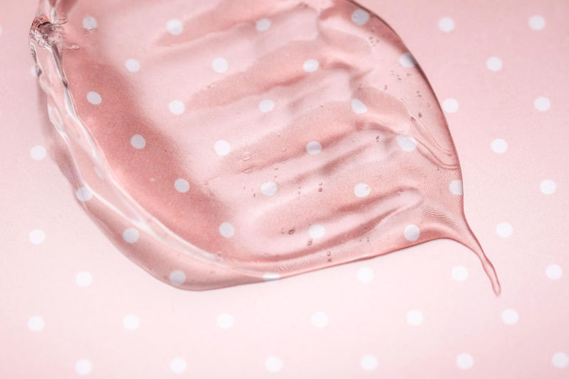 Transparent hyaluronic gel on a pink polka dots background.