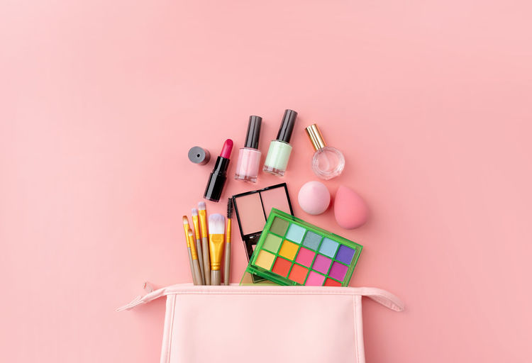 Directly above shot of beauty products on pink background
