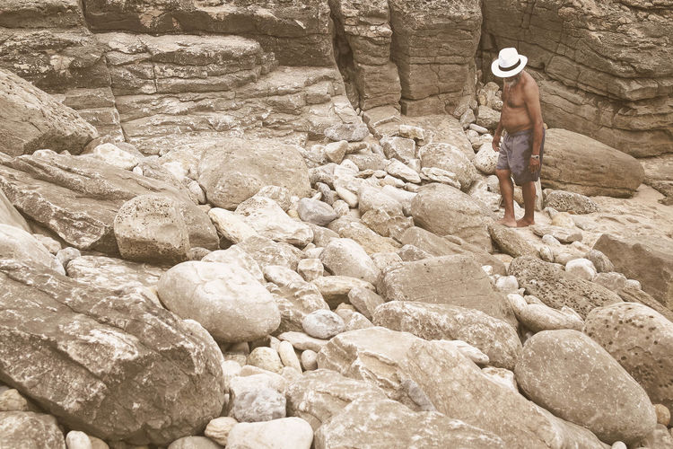 Full length of man walking on rocks