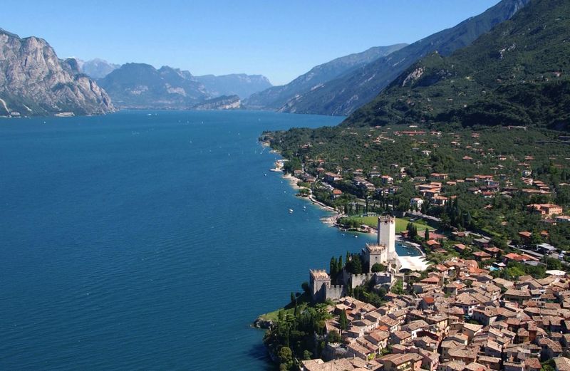 Scenic view of sea by town against sky